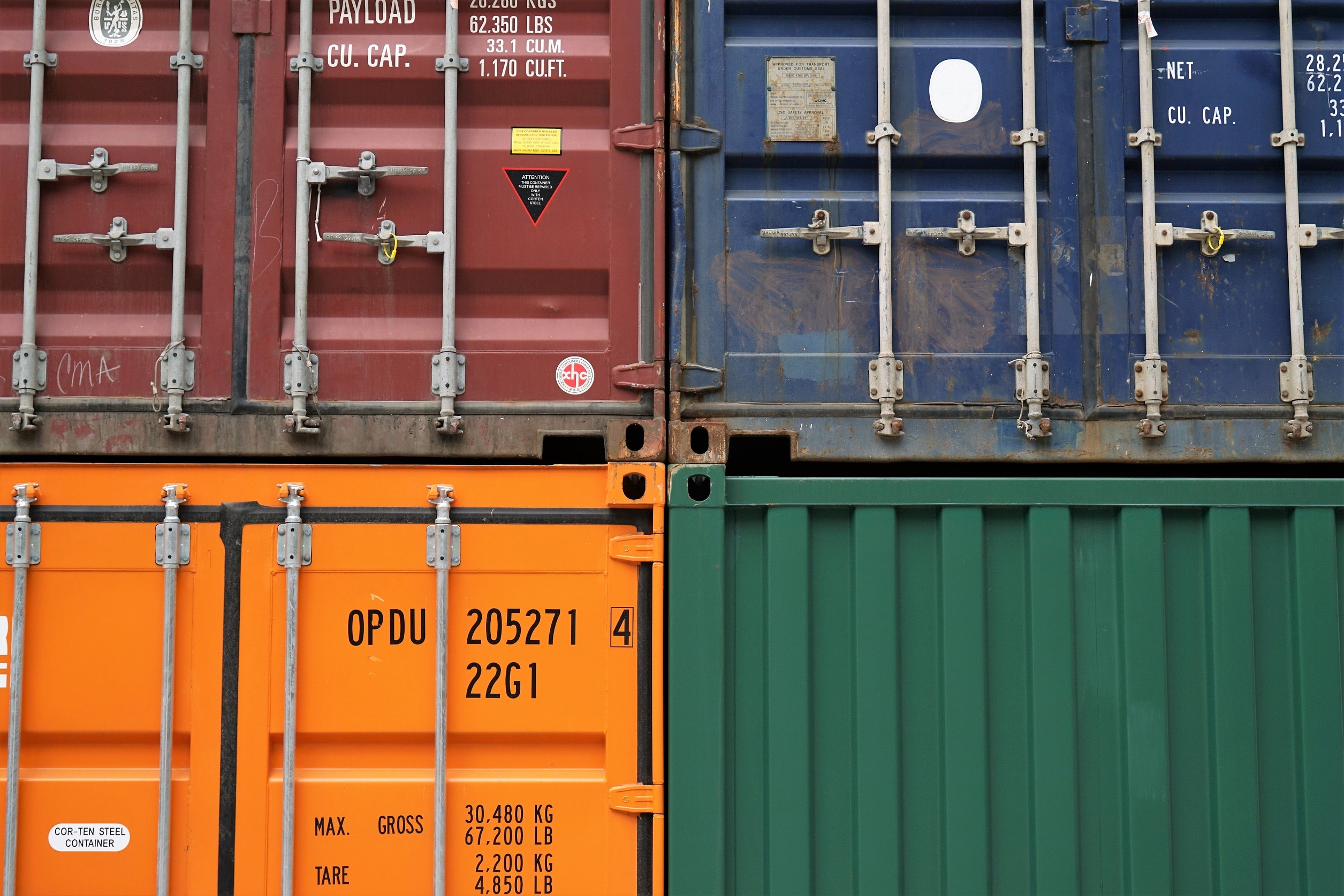 four container crates in blue, brown orange and green.